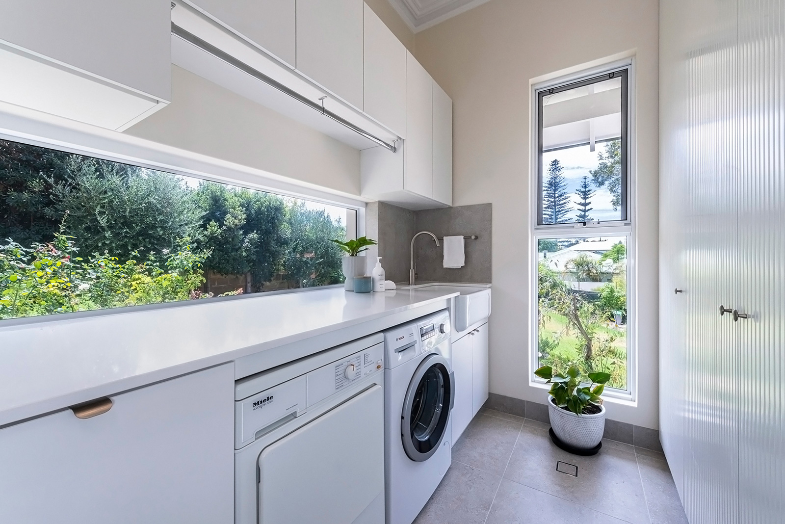 Laundry in Costtesloe apartment with cabinetry designed by Studio Seventy Four